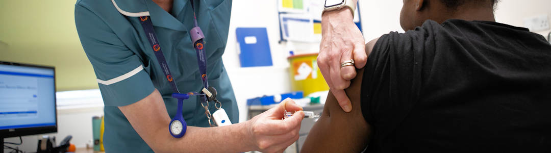 Midwife giving vaccination Midwife giving vaccination